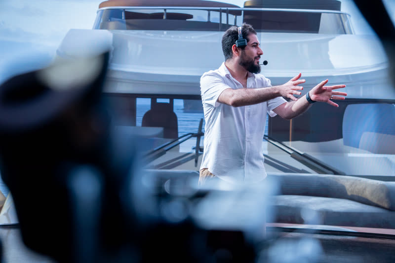Hamed Tayebi directing talent in front of an LED volume showing a yacht environment