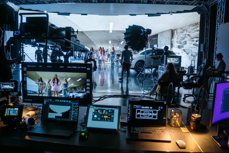 Virtual production control desk with monitors facing the LED volume stage